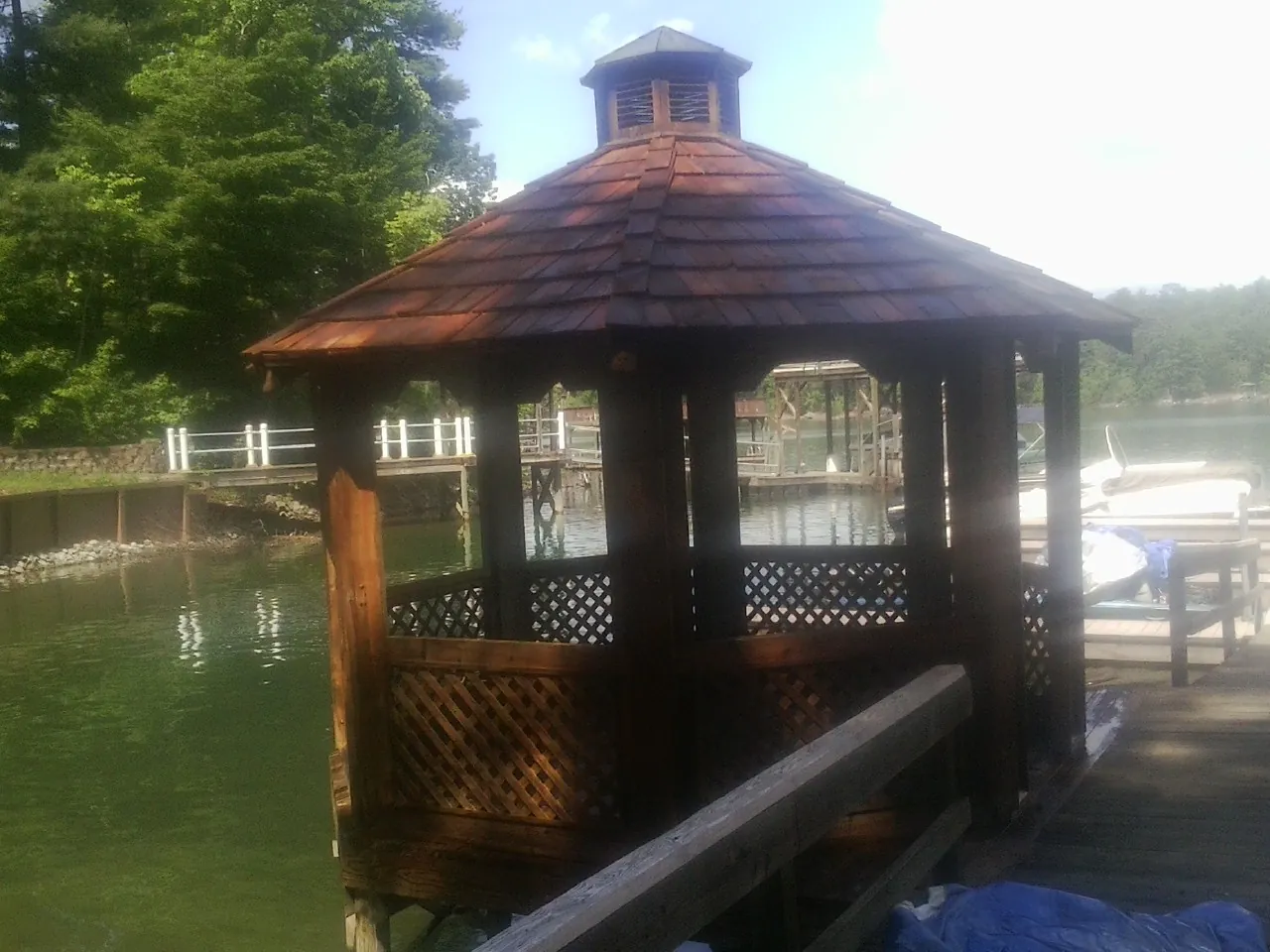 Cedar shake gazebo roof rebuilt on a lake dock in Hancock